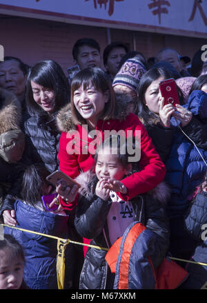 Chinese Americans come out to be entertained and participate in Chinese New Year celebrations in the Brooklyn, New York Chinatown in Sunset Park Brooklyn. Stock Photo
