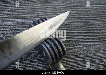 Knives stands next to the blade grinding tools, knife sharpening tool, blunt blades, sharpening with sharpening tools, grinding, Stock Photo