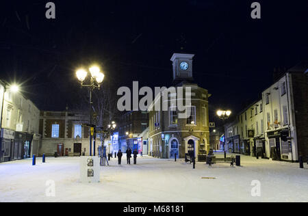 Three silhouette figures walking through Brigg Town Centre during 'Beast from the East' Storm of 2018 in Brigg, North Lincolnshire UK. Stock Photo