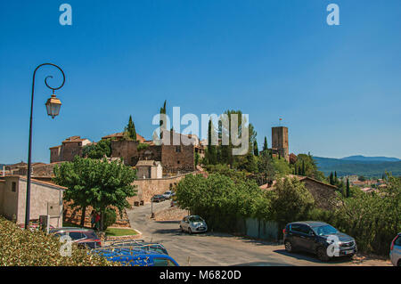 View of the lovely hamlet of Les Arcs-sur-Argens on top of a hill and under sunny blue sky. Located in the Provence region, southeastern France. Stock Photo