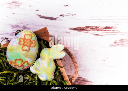 Easter gingerbread cookies in the grass on wooden table. Rabbit and egg. Greeting card. View from above.Copy space. Stock Photo
