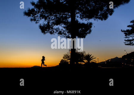 Argeles-sur-Mer (south-eastern France). Young woman running along the wateerfront in the early morning Stock Photo