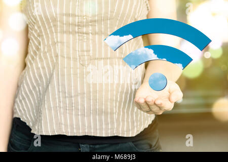Woman holding a wi-fi icon on a sunny day. Stock Photo
