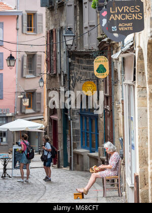 A lady sat making lace in the street Le Puy en Velay Haute-Loire Auvergne-Rhône-Alpes France Stock Photo