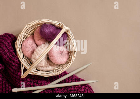 Balls of woolen threads and knitting needles. Scandinavian style. Threads for knitting in a basket. Stock Photo