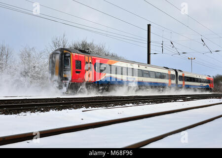 Winter snow, 158799 East Midlands Trains, East Coast Main Line Railway, Peterborough, Cambridgeshire, England, UK Stock Photo