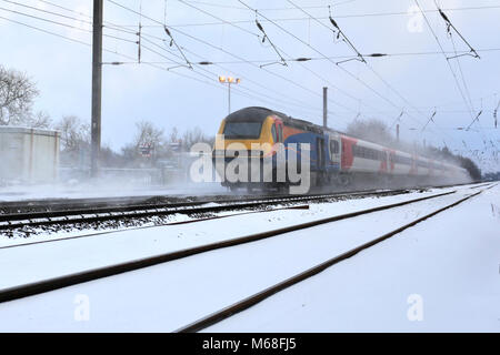 Winter snow, 43061 East Midlands Trains, East Coast Main Line Railway, Peterborough, Cambridgeshire, England, UK Stock Photo
