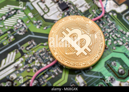 Circuit board and cryptocurrency Bitcoin coin Stock Photo