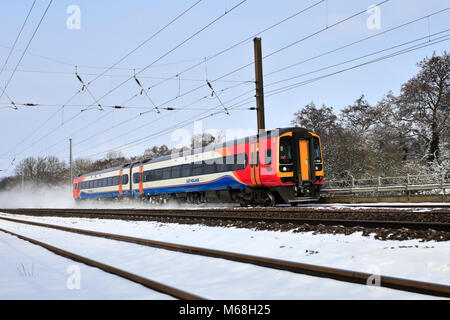 Winter snow, 158799 East Midlands Trains, East Coast Main Line Railway, Peterborough, Cambridgeshire, England, UK Stock Photo