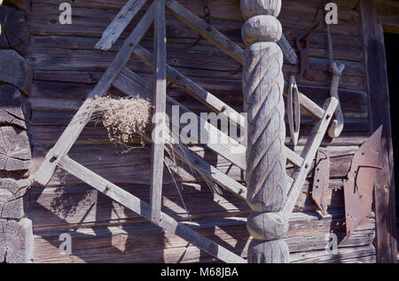 Various historical agriculture tools on old wooden barn wall Stock Photo