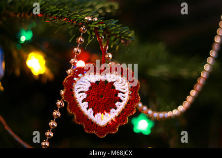 Handmade red and white heart-shaped Christmas tree ornament Stock Photo