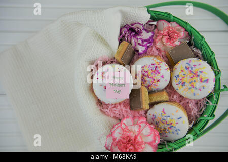 mothers day food of a gift with homemade cakes and biscuits and happy mothers day words or text Stock Photo
