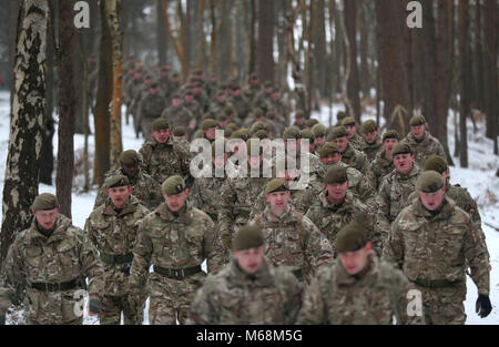 Members of 1st Battalion Welsh Guards make their way from their barracks to the combined St David's Day celebration and pre-deployment service at Elizabeth Barracks, Pirbright, Surrey. Stock Photo
