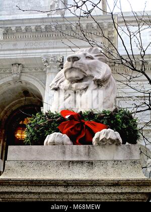 Holiday wreath on one of two stone lions that guard the entrance to the New York Public Library’s main branch on Fifth Avenue, New York.