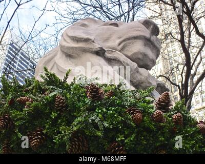 Holiday wreath on one of two stone lions that guard the entrance to the New York Public Library’s main branch on Fifth Avenue, New York.