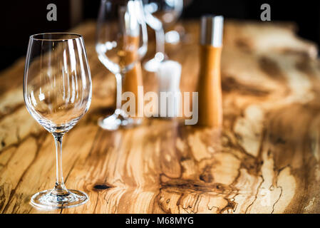 Empty wine glasses on slab table in restaurant Stock Photo