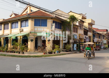 Street scene with french colonial buildings and tuk tuk, Kampot town, Cambodia Asia Stock Photo
