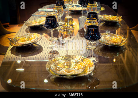 Table setting of luxurious glasses and plates in gold and black color Stock Photo