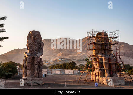 LUXOR, EGYPT - FEBRUARY 17, 2010: Two memnon colossi dedicated under restoration Stock Photo