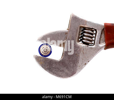 battery pressed on vintage adjustable wrench over white, image of a Stock Photo