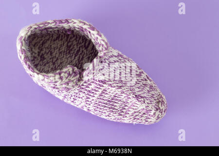 Handmade knitted wool sock isolated on violet background Stock Photo