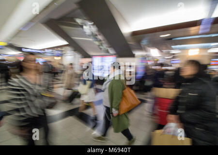 The busy concourse of Osaka train station, Japan, as people rush for trains. Stock Photo
