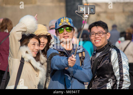 Tourists taking a selfie outside historic Osaka Castle in Japan Stock Photo