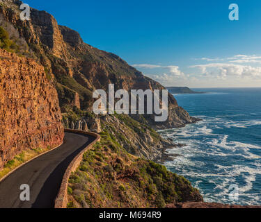 Driving from Hout Bay, near Cape Town, along the twisty Chapmanâ€™s Peak Road, the scenery is spectacular, as the road is cut into the rocks with the  Stock Photo
