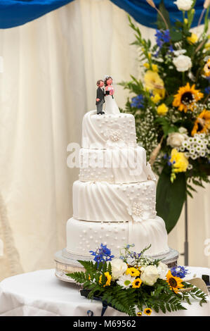 Wedding Day cake with his and hers figures sat on top of the iced cake Stock Photo