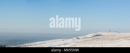 Looking across a snow covered Rivington Pike towards the Lancashire coast and Irish Sea Stock Photo