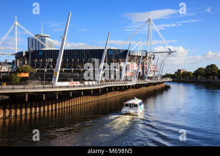 Cardiff Principality Stadium football and rugby venue with watertaxi passing on the River Taff. Cardiff (Caerdydd) South Glamorgan Wales UK Britain Stock Photo