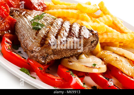 Grilled steak, French fries and vegetables Stock Photo