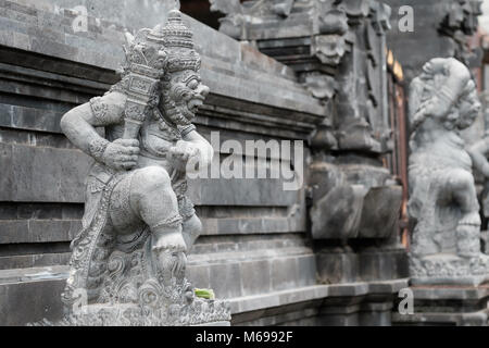 BALI, INDONESIA - DECEMBER 13, 2017: carved statue stand outside entrance to Hindu temple Stock Photo