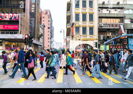 16 February 2018 - Hong Kong. Pedestrians at Hong Kong. Crowds of people crossing the busy city road. Stock Photo