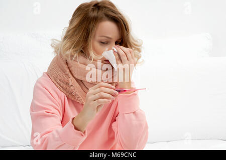 Woman having a cold, flu. Sore throat, coughing and fever Stock Photo