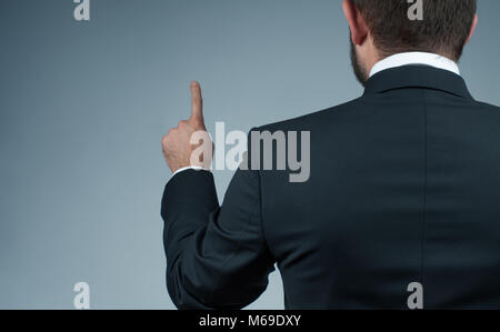 Businessman touching on the whiteboard. Businessman pressing buttons in the air Stock Photo
