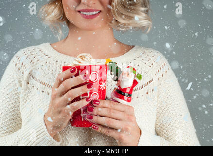 Beautiful woman holding cup of coffee. Christmas and New Year Stock Photo
