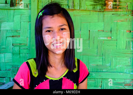 Portrait of a smiling beautiful young woman wearing Thanaka, the yellow face paste Stock Photo