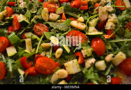 Delicious Food Healthy Mixed Vegetable Salad Texture with Arugula, Tomato, Garlic, Zucchini, and Onion Stock Photo