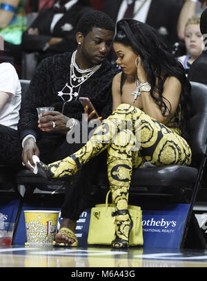 Keyshia Ka'Oir, left, wife of rapper Gucci Mane, right, pose for  photographs at courtside prior to the NBA All-Star Game at Spectrum Center  in Charlotte, N.C. on Sunday, February 17, 2019. (Photo