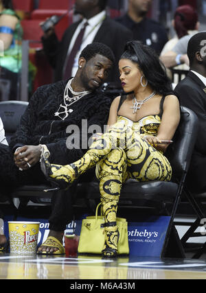 Keyshia Ka'Oir, left, wife of rapper Gucci Mane, right, pose for  photographs at courtside prior to the NBA All-Star Game at Spectrum Center  in Charlotte, N.C. on Sunday, February 17, 2019. (Photo