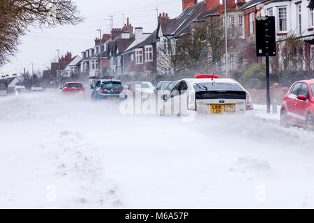 Northampton, England. 2nd Mar, 2018. UK Weather:. Slow moving commuter traffic on Park Ave South due to snow which is blowing off Abington Park in the strong winds and  drifting across the road,  temperatures of -6 overnight not counting for wind chill . Credit: Keith J Smith./Alamy Live News Stock Photo