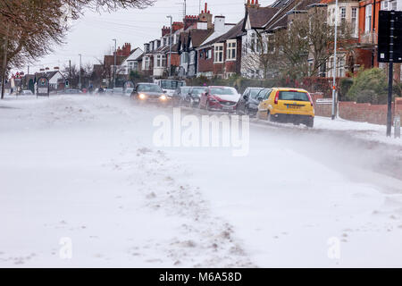 Northampton, England. 2nd Mar, 2018. UK Weather:. Slow moving commuter traffic on Park Ave South due to snow which is blowing off Abington Park in the strong winds and  drifting across the road,  temperatures of -6 overnight not counting for wind chill . Credit: Keith J Smith./Alamy Live News Stock Photo