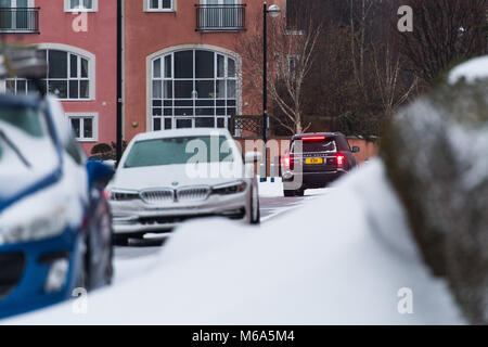 Penarth, Wales. 2nd March 2018. A car attempts to drive along an icy road surrounded by snowdrifts. Storm Emma and 'The Beast From The East' have hit the UK, with a red alert for snow and wind issued for areas surrounding Cardiff, Newport, the South Wales valleys, and south west England. Credit: Polly Thomas/Alamy Live News Stock Photo