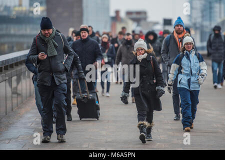 London, UK. 2nd Mar, 2018. UK Weather: The Beast from the East? More like hysteria from Siberia, some say. Commuters struggle accross London Bridge in freezing temperatures. The weather forcasters predicted heavy snow but it is only cold and not even that windy. Credit: Guy Bell/Alamy Live News Stock Photo