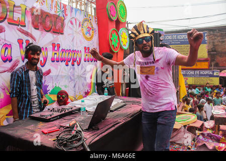 Guwahati, Assam, India. 2nd Mar, 2018. Coloured powder is thrown on men as they dance during Holi celebrations on street at Fancy Bazar, Guwahati, Assam, India. Credit: David Talukdar/Alamy Live News Stock Photo