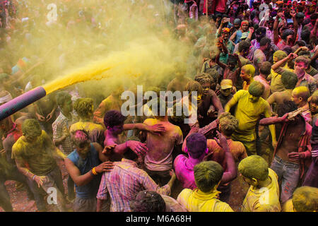 Guwahati, Assam, India. 2nd Mar, 2018. Coloured powder is thrown on men as they dance during Holi celebrations on street at Fancy Bazar, Guwahati, Assam, India. Credit: David Talukdar/Alamy Live News Stock Photo