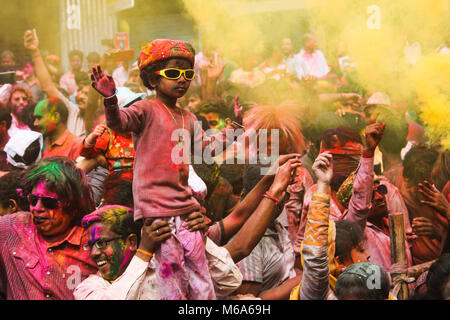 Guwahati, Assam, India. 2nd Mar, 2018. Coloured powder is thrown on men as they dance during Holi celebrations on street at Fancy Bazar, Guwahati, Assam, India. Credit: David Talukdar/Alamy Live News Stock Photo