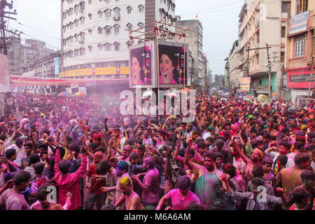 Guwahati, Assam, India. 2nd Mar, 2018. Coloured powder is thrown on men as they dance during Holi celebrations on street at Fancy Bazar, Guwahati, Assam, India. Credit: David Talukdar/Alamy Live News Stock Photo