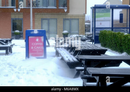 Portishead, Somerset, UK. 2nd March, 2018. UK Weather, Portishead, N. Somerset, UK  Storm Emma left deep snow drifts and icy conditions across the west country today. More snow is forecast for later this afternoon and a Yellow warning for more snow is in place. The outsdie table at this local cafe are deserted Credit: Stephen Hyde/Alamy Live News Stock Photo